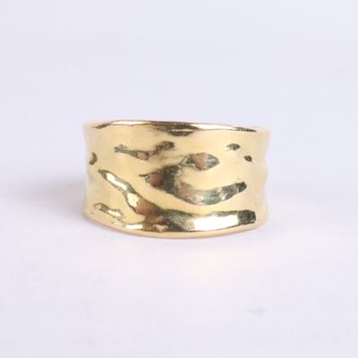 a close up of a gold ring on a white surface