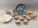 many pieces of pottery that are sitting on a table