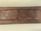 a brown leather belt with a metal buckle on it