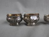 three silver bowls with numbers on them sitting on a table