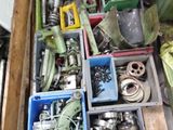 a box full of assorted metal items sitting on the floor