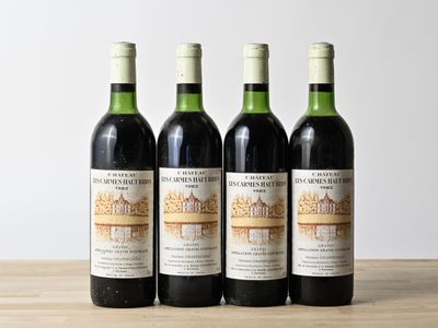 three bottles of wine sitting on top of a wooden table