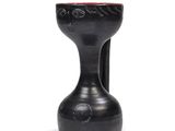 a black vase with a red top sitting on a white surface