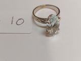 a ring with a stone on it sitting on top of a table