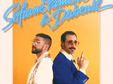 two men in suits and sunglasses standing next to each other