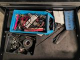 a blue box filled with assorted items on the floor