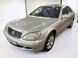 a silver car that is parked in a white room