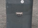 a metal trash can with a yellow tag on top of it