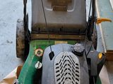 a lawn mower that is sitting on the ground