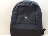 the backpack is blue and black with a small logo on the front