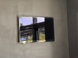 une photo d'un téléviseur accroché au mur dans une pièce