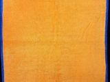 a close up of a yellow and blue towel on a black background