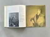 an open book with a drawing of a man sitting on a chair