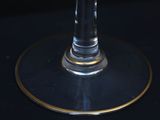 a glass of wine sitting on top of a black table