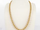 a gold beaded necklace on a mannequin mannequin mannequin mannequin mannequin mannequin mannequin mannequin mann