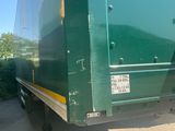 a large green truck that is parked in the parking lot