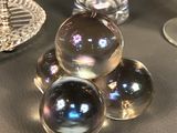 a table with a glass vase and a plate with a glass ball on it
