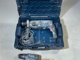 a corded drill in a case and a corded drill in a case