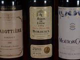 three bottles of wine are lined up on a table