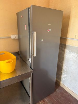 a refrigerator and a bowl on a table in a kitchen