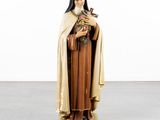 statue of a woman holding a cat and a bird in her hands