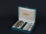 a set of six silver plated spoons in a blue case