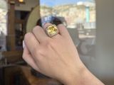 a person that is holding a ring in their hand