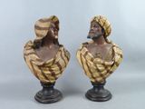 une paire de bustes en bronze représentant un homme et une femme portant un turban sur la tête