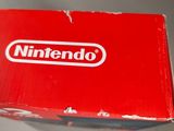 someone is holding a nintendo wii game controller in their hand