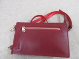 a red purse with a zipper on the side