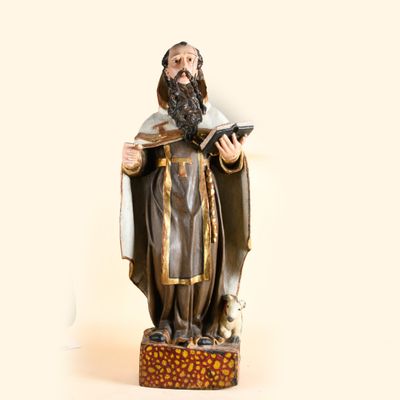 a statue of a man with a beard holding a book