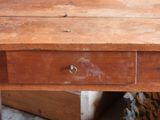 a small wooden table with a drawer on it