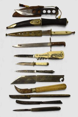 many different types of knives on a white surface