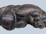 an image of a statue of a dog laying down on its back