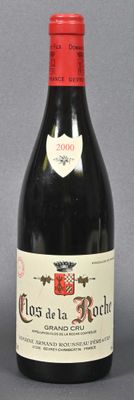 bottle of red wine sitting on a table with a gray background