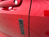 a close up of a car door handle with a sticker on it