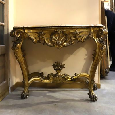 a gold table with a clock on top of it