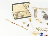 a lot of jewelry on a white surface