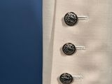 a close up of a coat with buttons on it