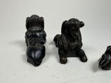 three figurines of animals that are sitting on a table
