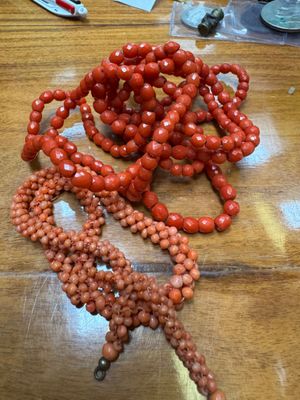 a table with a bunch of red beads on it