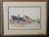framed watercolor painting of a street scene with buildings and trees