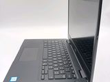 a black laptop computer sitting on top of a white table
