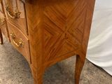 an image of a marble top chest of drawers in a room