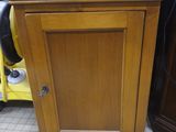 a wooden cabinet with a blue sign on top of it