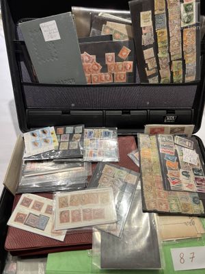 a suitcase full of stamps and other items in it