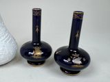 two vases sitting next to each other on a table