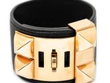 a close up of a black leather bracelet with gold rivets