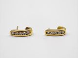 a pair of gold and diamond earrings