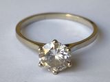 gros plan d'une bague en diamant sur une surface blanche